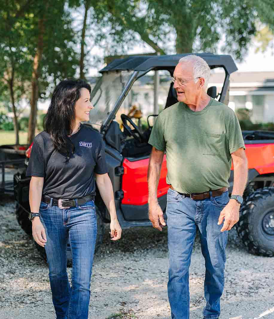 Rena walks with a farmer talking